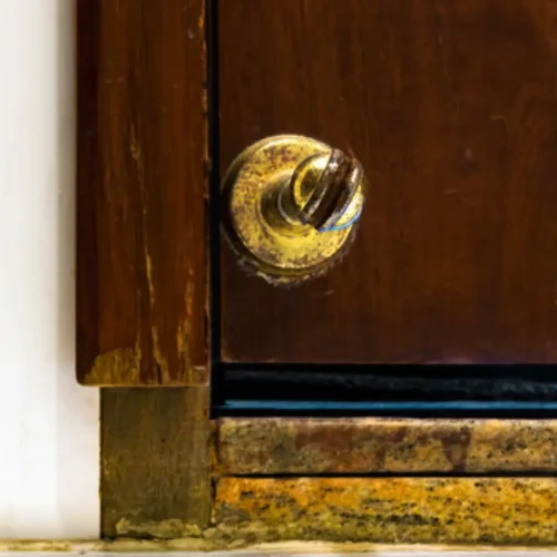 A worn-out traditional door stoppers, showing cracks, discoloration, and damage from frequent use.